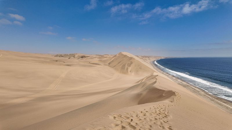 Giant sand dunes meeting the Atlantic at Sandwich Harbour
